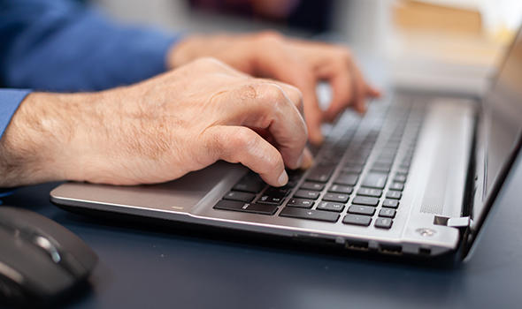 Freepik_close-up-of-senior-man-hands-typing-on-laptop-keyboard_DCStudio.jpg